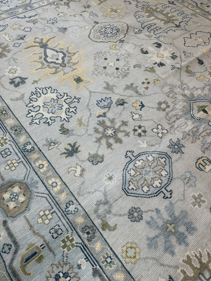 Margot modern Oushak rug, hand-knotted wool with a gray center, light blue border, and mustard, green, cream, and navy accents