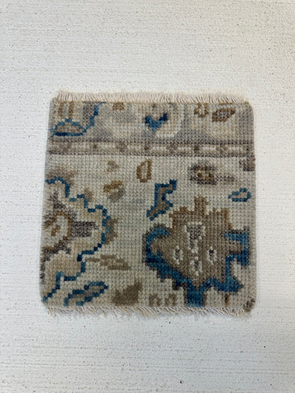 Ollie gray modern Oushak rug with blue undertones, taupe border, and cobalt, cream, and tan accents, hand-knotted wool