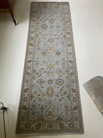 Katherine modern Oushak rug, hand-knotted wool with a light blue base and cream, tan, ochre, and soft green accents