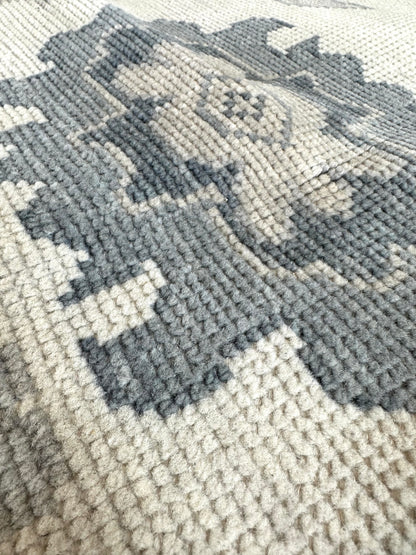 Close-up of Emma Modern Oushak rug showing cream, gray, soft cream, calming blues, hand-knotted wool (view 13)