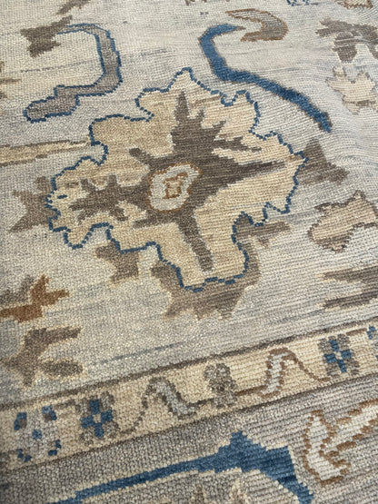 Ollie hand-knotted wool modern Oushak rug in cool gray with blue undertones and taupe, cobalt, and tan accents