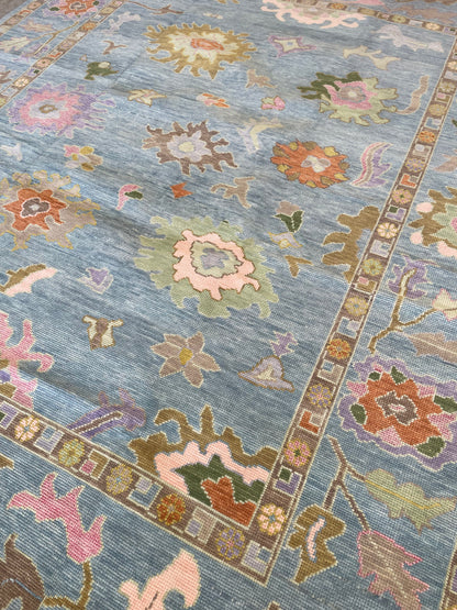 Close-up of Gracie Modern Oushak rug showing blue-green, orange, pink, purple, green, tans, hand-knotted wool