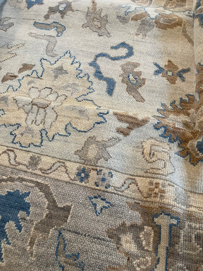 Ollie cool gray modern Oushak rug with a taupe border and cobalt blue, cream, and brown accents, hand-knotted wool