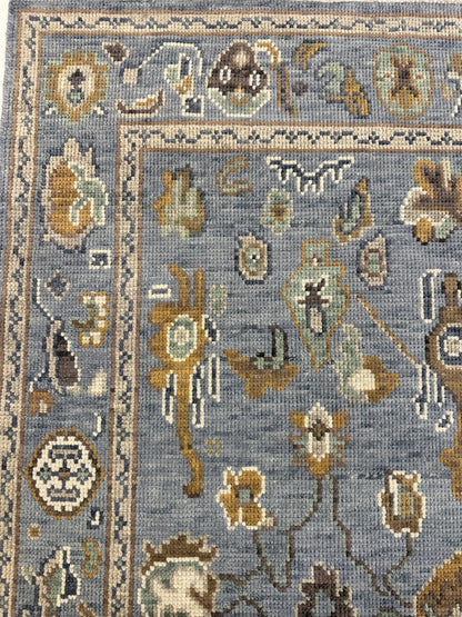 Mae modern Oushak rug with a blue-gray foundation and cream, mustard, sage, and brown accents, hand-knotted wool