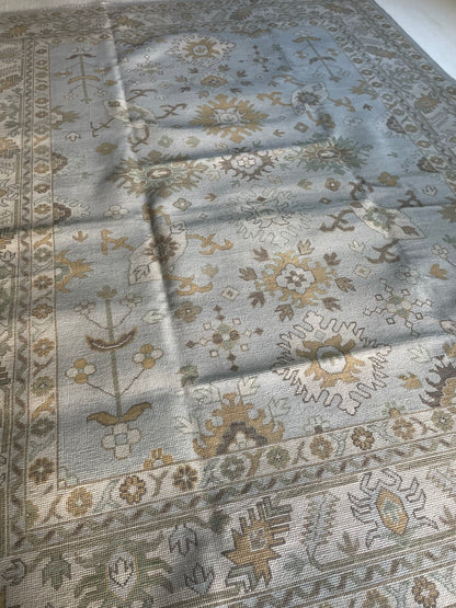 Katherine modern Oushak rug, hand-knotted wool with a light blue base and cream, tan, ochre, and soft green accents