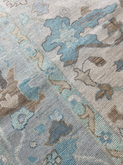 Maggie modern Oushak rug, a warm gray foundation, cool gray border, and aqua and turquoise accents