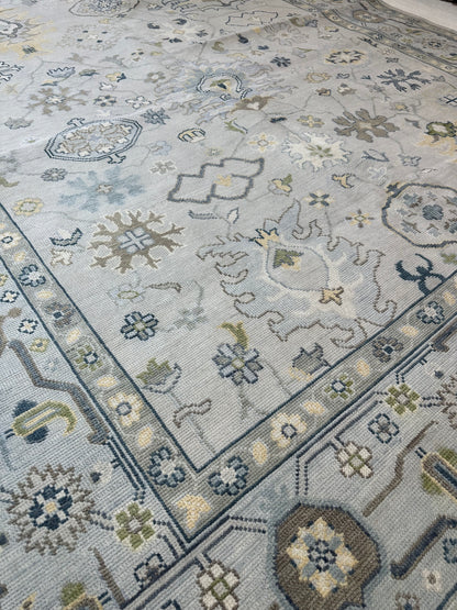 Margot modern Oushak rug, a gray center, light blue border, and mustard, green, cream, and navy accents