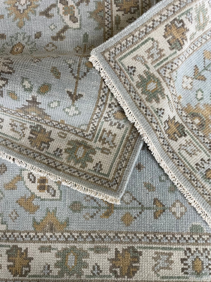 Katherine modern Oushak rug, light blue with cream, tan, ochre, and soft green accents