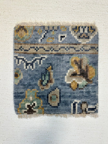 Mae modern Oushak rug with a blue-gray foundation and cream, mustard, sage, and brown accents, hand-knotted wool
