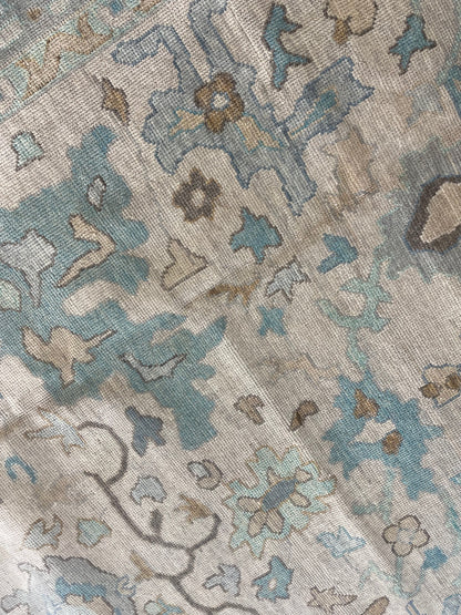 Maggie modern Oushak rug with a warm gray foundation, cool gray border, and aqua and turquoise accents, hand-knotted wool