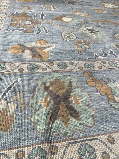 Mae hand-knotted wool modern Oushak rug in a blue-gray foundation and cream, mustard, sage, and brown accents