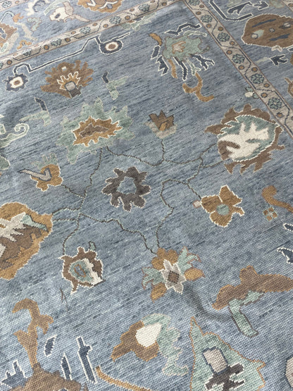 Mae modern Oushak rug, a blue-gray foundation and cream, mustard, sage, and brown accents