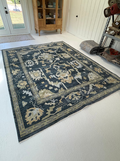 Eloise Modern Oushak rug styled in a room, moody blue-green, cream, olive, light blue, tan, hand-knotted wool