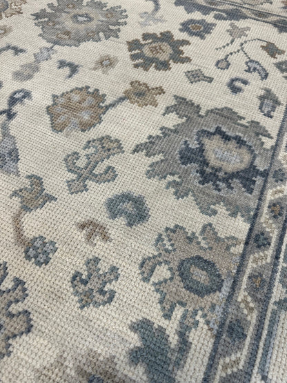 Close-up of Emma Modern Oushak rug showing cream, gray, soft cream, calming blues, hand-knotted wool
