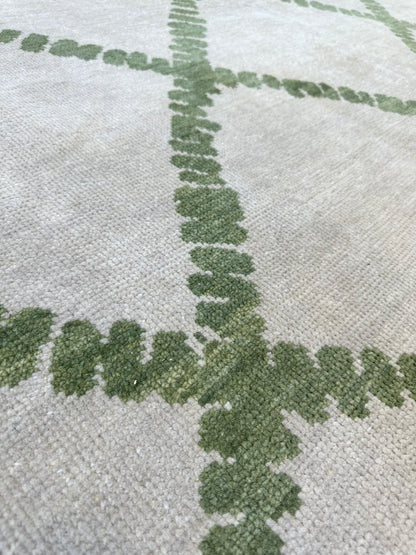 Lynn hand-knotted wool modern Oushak rug in a very light warm gray foundation and soft green accents