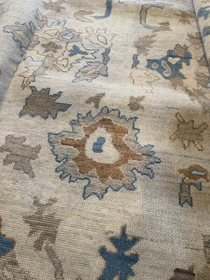 Ollie gray and taupe modern Oushak rug with cobalt blue, cream, and brown accents, hand-knotted wool