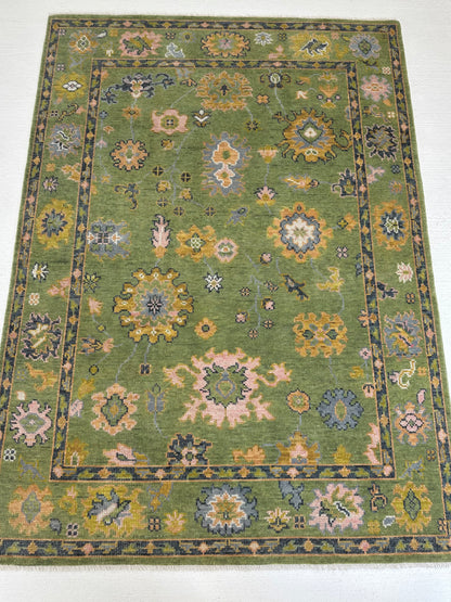 Linda modern Oushak rug with a lime green foundation and slate blue, pink, chartreuse, cream, and orange accents, hand-knotted wool