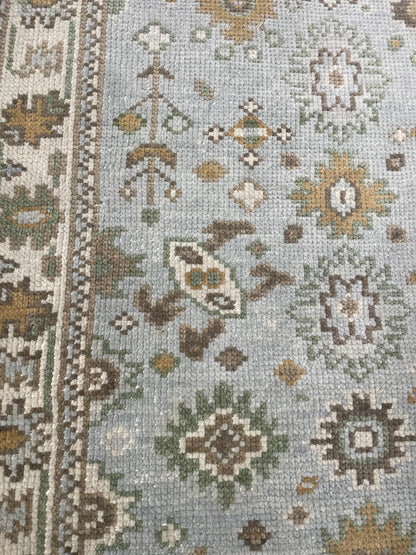 Katherine light blue modern Oushak rug with cream, tan, ochre, and soft green, hand-knotted wool